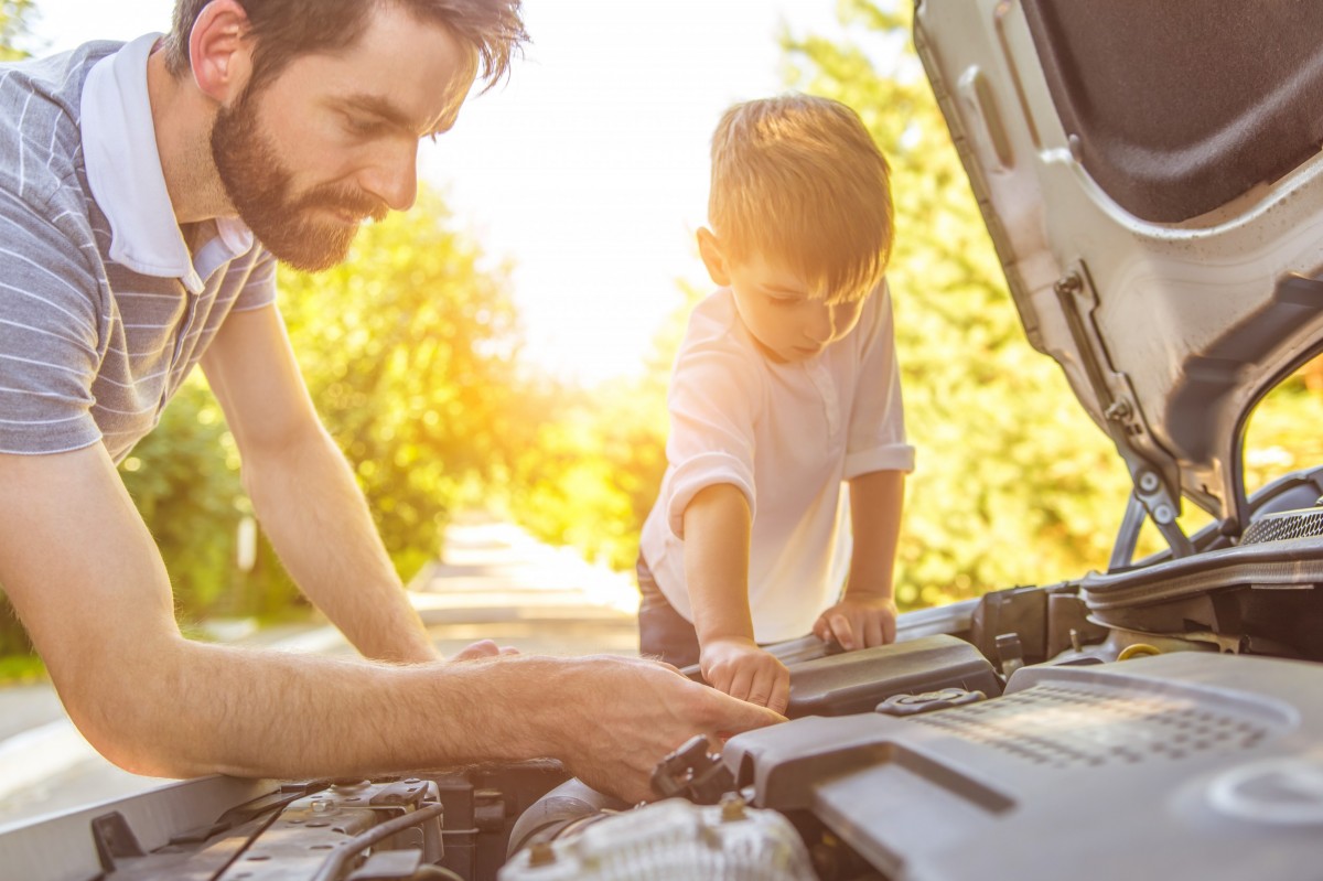 father son working on car