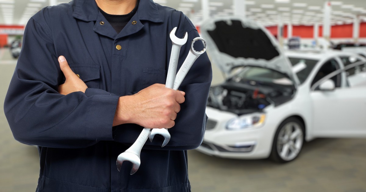 mechanic holding two wrenches