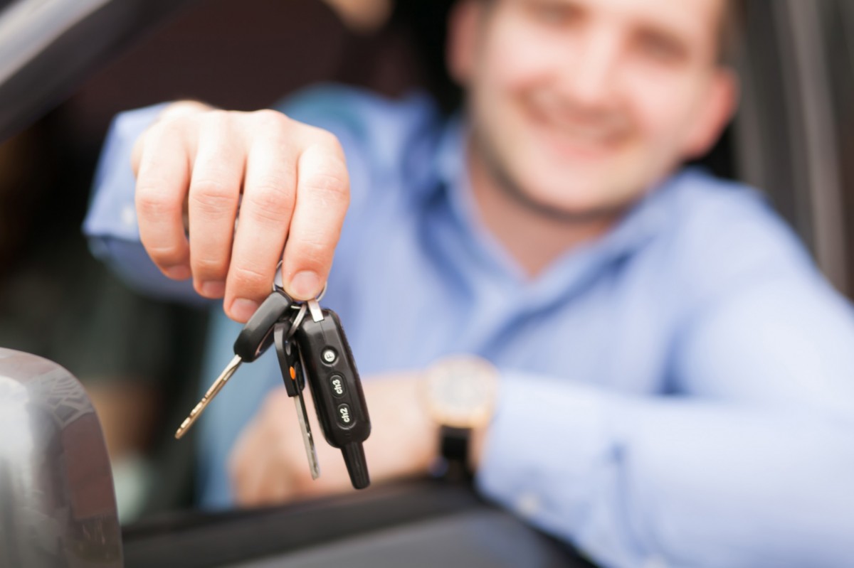 man holding car keys
